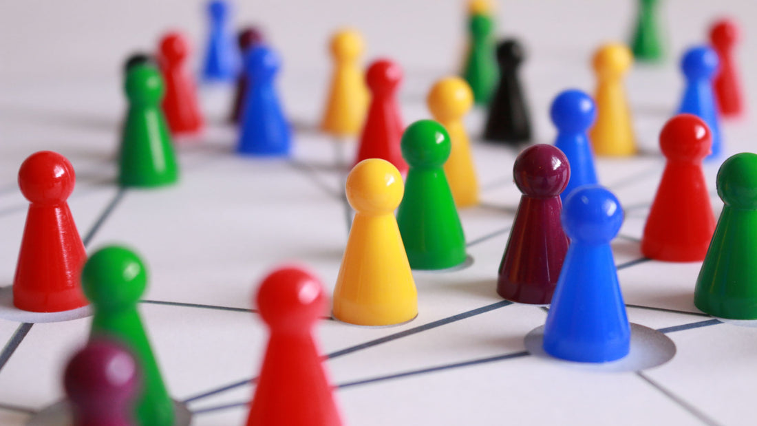 coloured plastic people-shaped counters grouped together to symbolise community