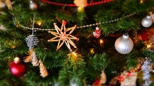 close up of decorations on green christmas tree